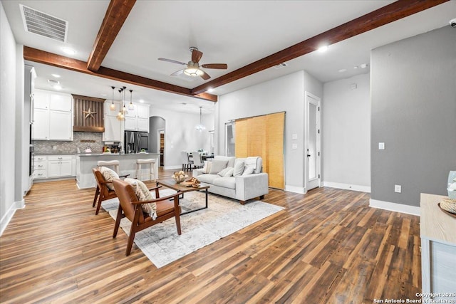 1547 Moon Vw, New Braunfels, TX 78132 - living room featuring beam ceiling, ceiling fan, light wood-type flooring, arched walkways, and baseboards