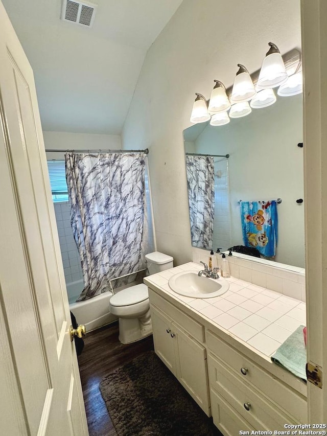 607 Dover Ln, Round Rock, TX 78664 - full bathroom with visible vents, toilet, vaulted ceiling, wood finished floors, and vanity
