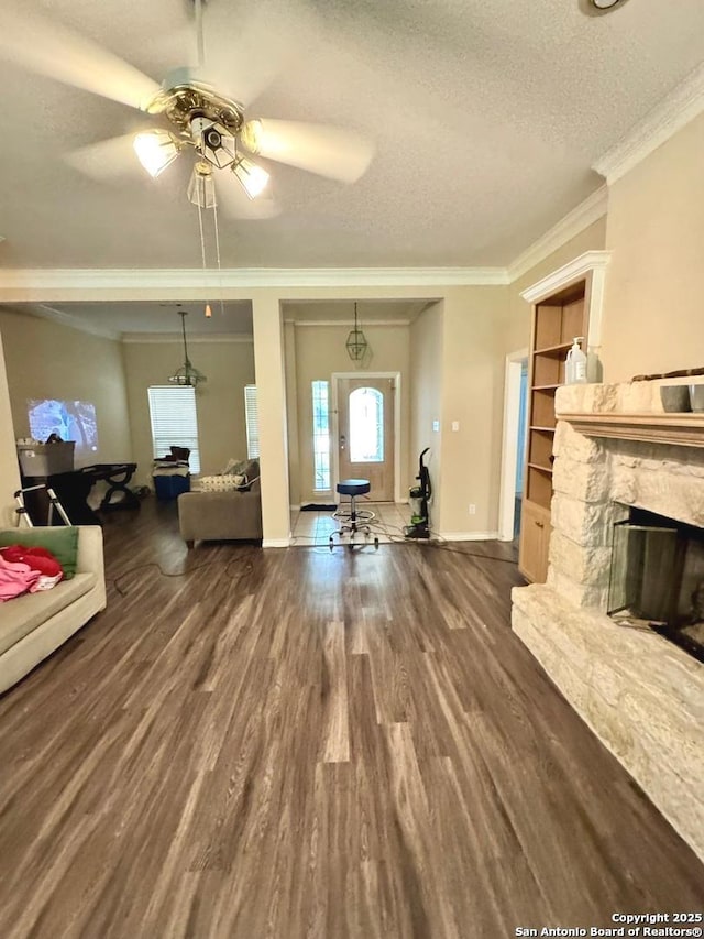 607 Dover Ln, Round Rock, TX 78664 - living area with wood finished floors, a fireplace, baseboards, a ceiling fan, and a textured ceiling