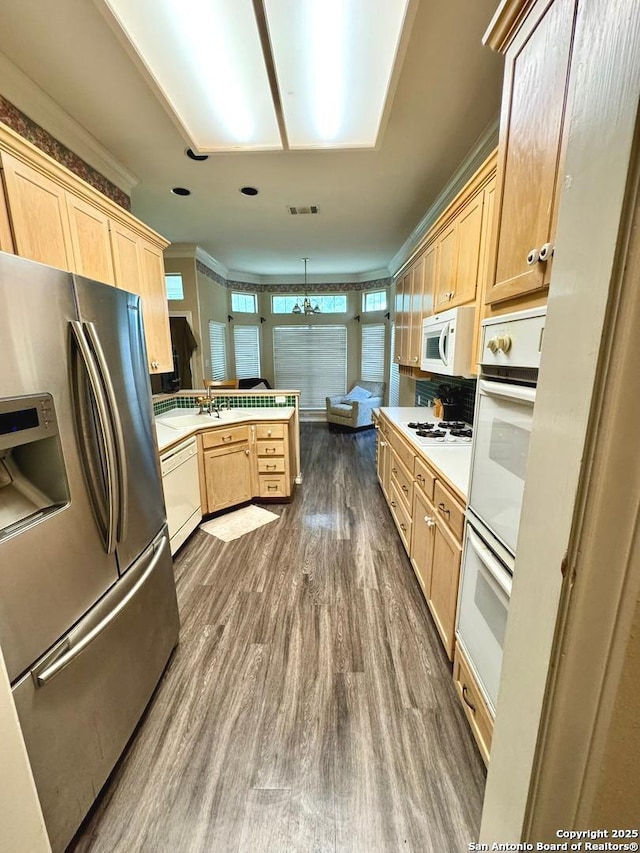 607 Dover Ln, Round Rock, TX 78664 - kitchen featuring light brown cabinetry, dark wood-style flooring, white appliances, and a peninsula