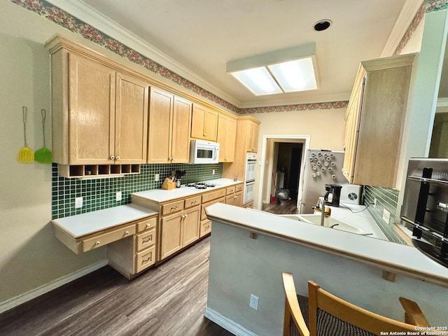 607 Dover Ln, Round Rock, TX 78664 - kitchen featuring light brown cabinetry, dark wood-style flooring, a peninsula, and white appliances
