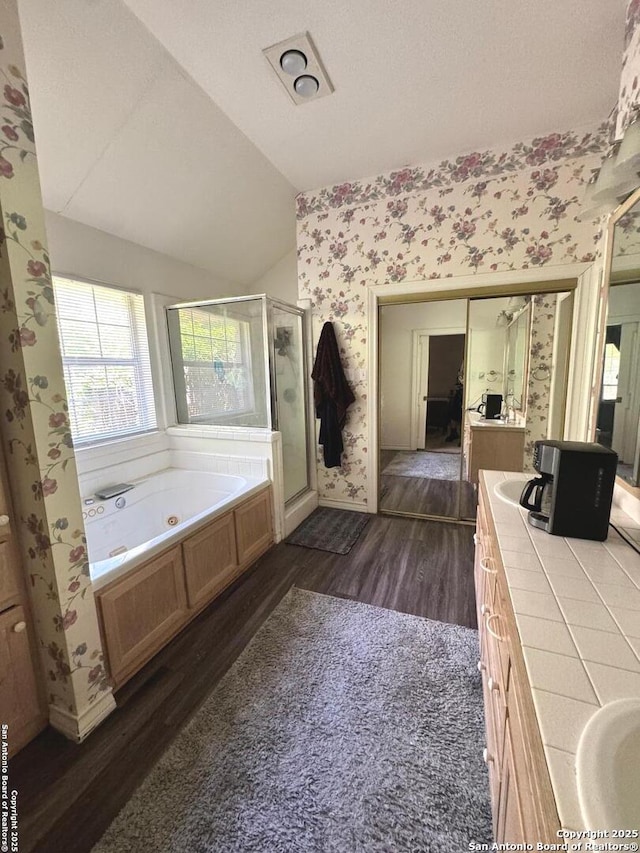 607 Dover Ln, Round Rock, TX 78664 - bathroom featuring vanity, wood finished floors, a shower stall, and wallpapered walls