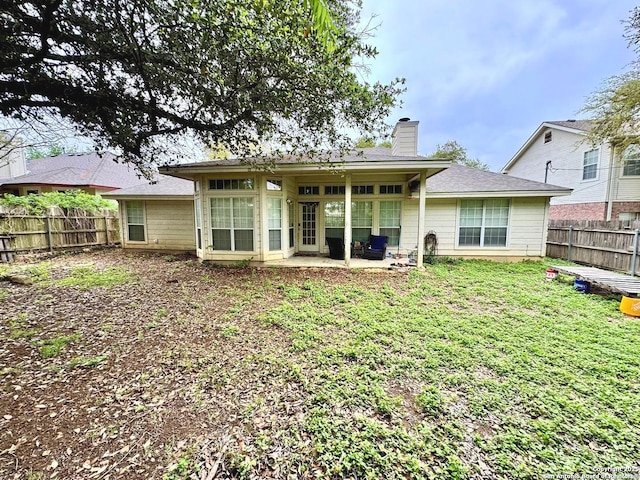 607 Dover Ln, Round Rock, TX 78664 - back of property featuring a patio, a yard, a fenced backyard, and a chimney