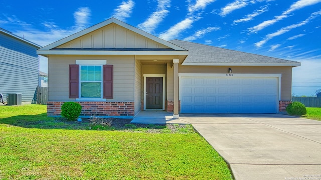 13406 Flower Pond, Saint Hedwig, TX 78152 - view of front facade featuring brick siding, central air condition unit, driveway, a front yard, and an attached garage