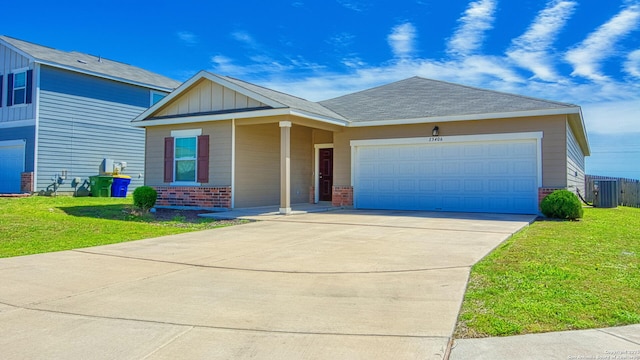 13406 Flower Pond, Saint Hedwig, TX 78152 - view of front of house featuring a front lawn, concrete driveway, an attached garage, and brick siding