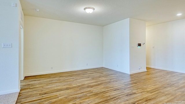 13406 Flower Pond, Saint Hedwig, TX 78152 - spare room featuring light wood-style flooring and baseboards
