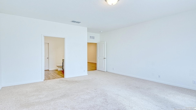 13406 Flower Pond, Saint Hedwig, TX 78152 - unfurnished bedroom featuring light colored carpet, visible vents, ensuite bath, and baseboards