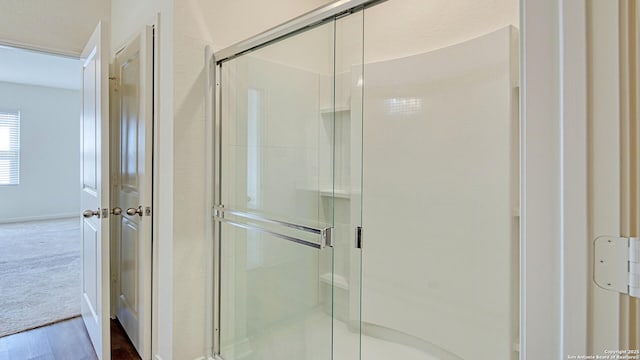 13406 Flower Pond, Saint Hedwig, TX 78152 - full bathroom featuring wood finished floors, a stall shower, and baseboards