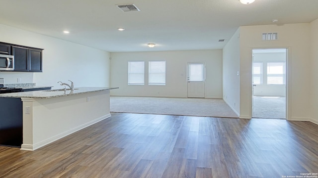 13406 Flower Pond, Saint Hedwig, TX 78152 - kitchen featuring a sink, visible vents, wood finished floors, and stainless steel microwave