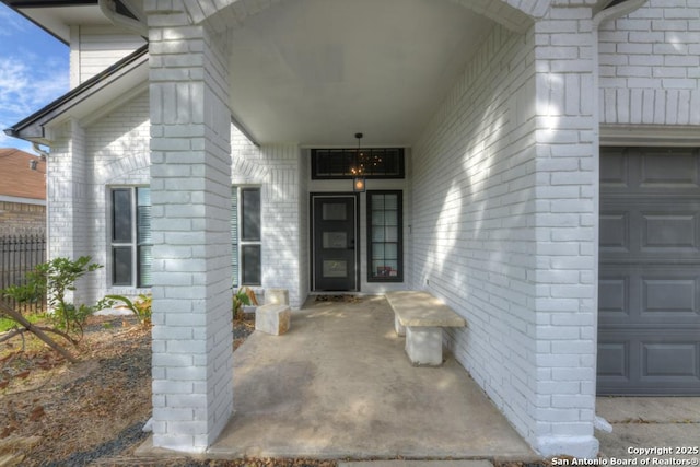 property entrance featuring a garage and fence