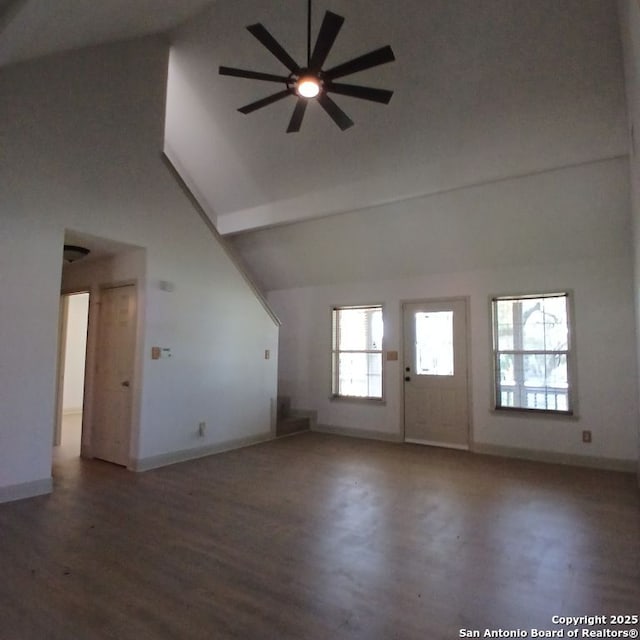 additional living space with wood finished floors, a ceiling fan, high vaulted ceiling, and baseboards