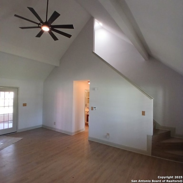 interior space featuring high vaulted ceiling, wood finished floors, a ceiling fan, and stairway