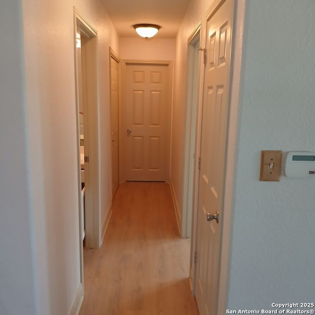 corridor with light wood-style floors