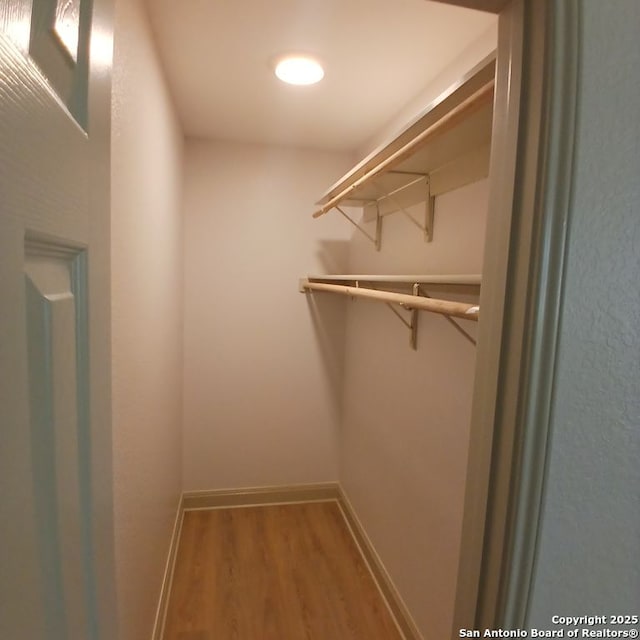 spacious closet with wood finished floors