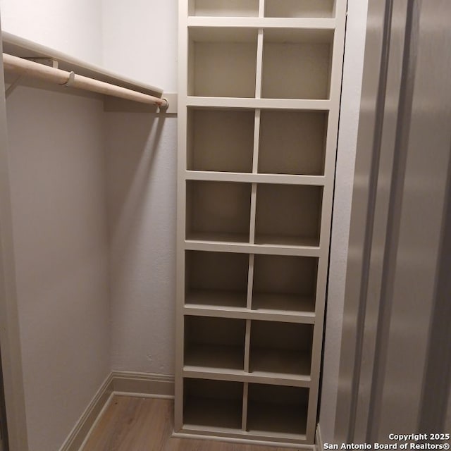 spacious closet with wood finished floors