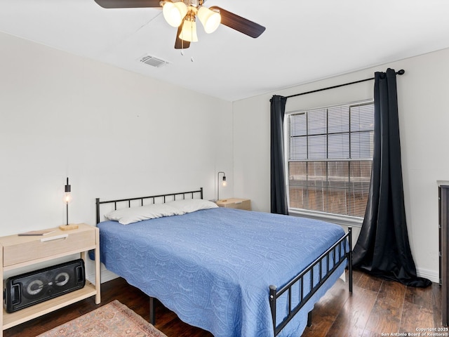 bedroom featuring visible vents, ceiling fan, and wood-type flooring