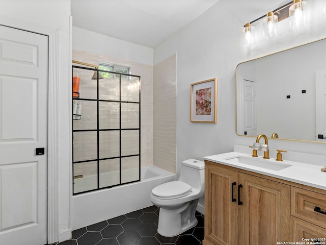 bathroom featuring bath / shower combo with glass door, vanity, toilet, and tile patterned flooring