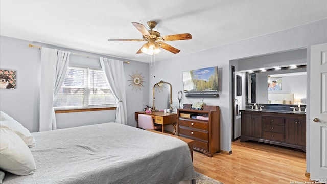 8422 Timber Crst, San Antonio, TX 78250 - bedroom with a ceiling fan, ensuite bath, and light wood-style flooring