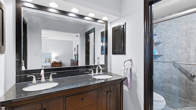 8422 Timber Crst, San Antonio, TX 78250 - full bathroom featuring toilet, ensuite bath, a stall shower, and a sink