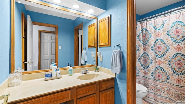 8422 Timber Crst, San Antonio, TX 78250 - bathroom featuring vanity, toilet, a textured wall, and a shower with shower curtain