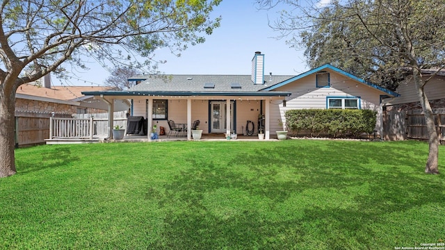 8422 Timber Crst, San Antonio, TX 78250 - back of house featuring a chimney, fence private yard, and a yard