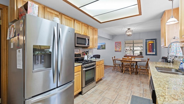 8422 Timber Crst, San Antonio, TX 78250 - kitchen with a sink, light brown cabinets, a notable chandelier, pendant lighting, and appliances with stainless steel finishes