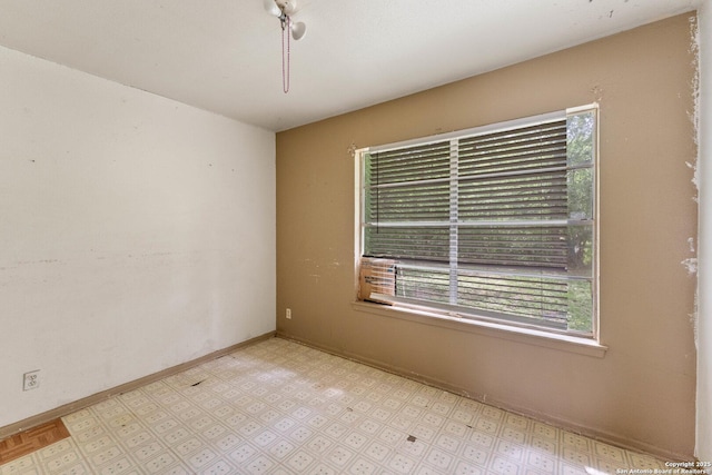 unfurnished room with baseboards and light floors