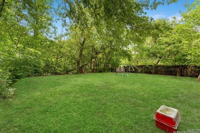 view of yard featuring a playground and a fenced backyard