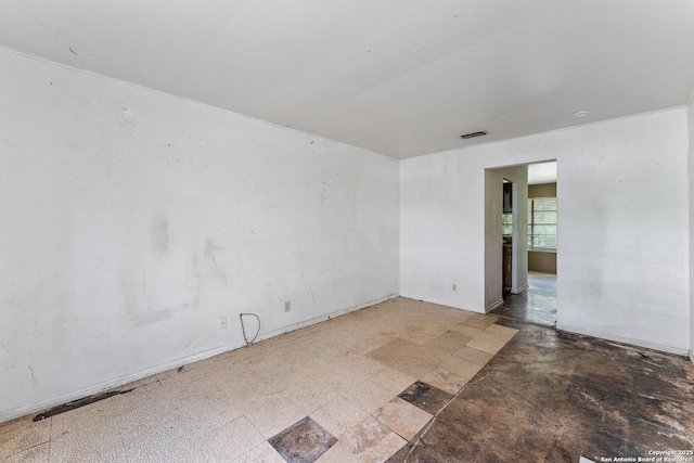 unfurnished room featuring visible vents