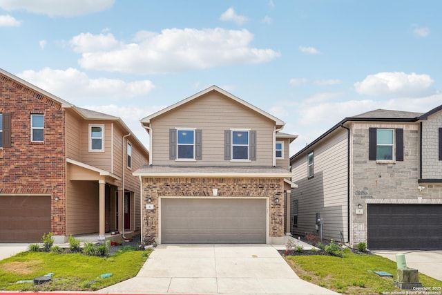view of front of house with an attached garage, driveway, and brick siding
