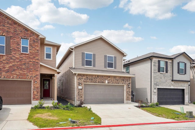 view of front of property with brick siding, driveway, and a garage