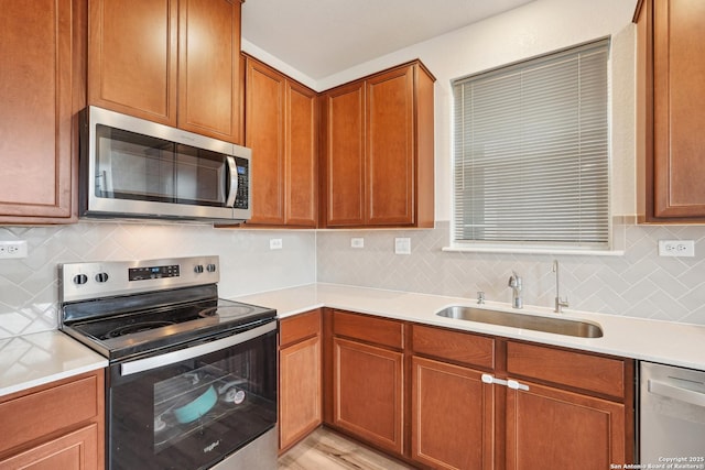 kitchen with light countertops, stainless steel appliances, and a sink