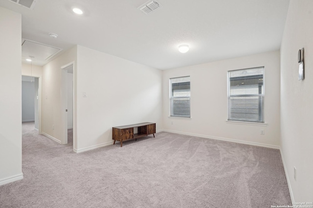 carpeted empty room with visible vents, attic access, baseboards, and recessed lighting