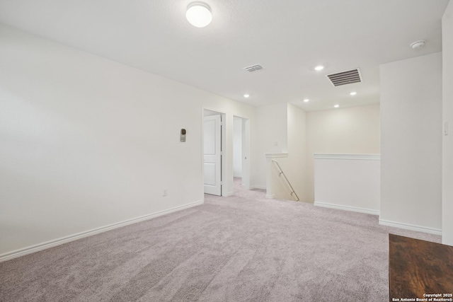 unfurnished room with visible vents, recessed lighting, baseboards, and light carpet