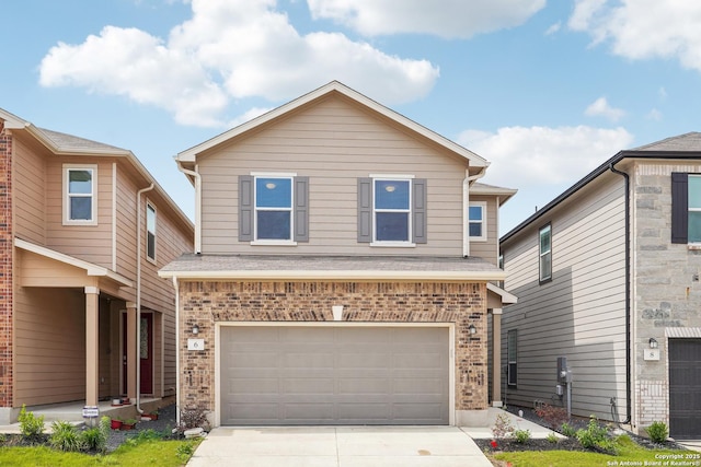 traditional-style house featuring a garage, concrete driveway, and brick siding