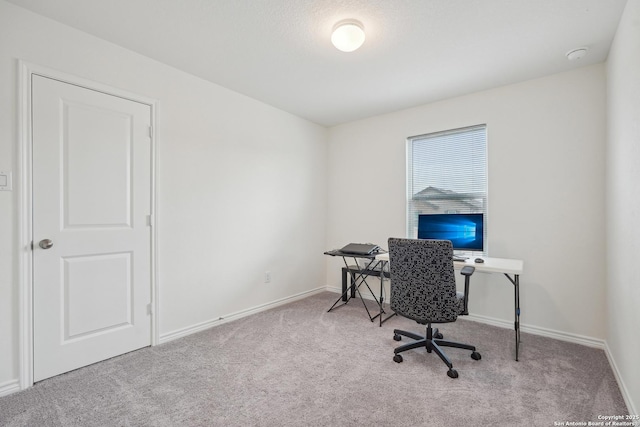 carpeted home office featuring baseboards