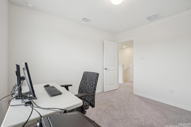 carpeted office space featuring baseboards and visible vents