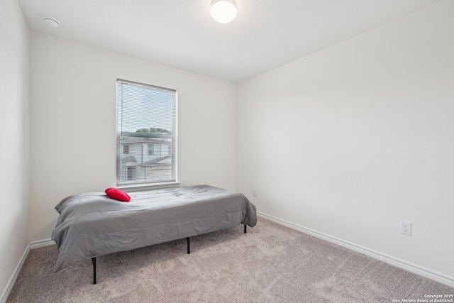 carpeted bedroom featuring baseboards