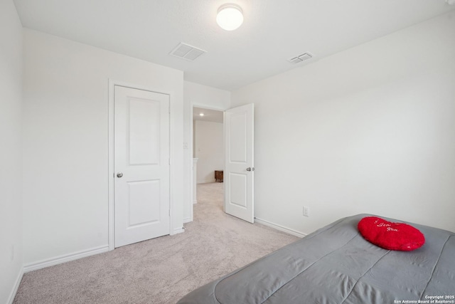unfurnished bedroom featuring baseboards, visible vents, and carpet