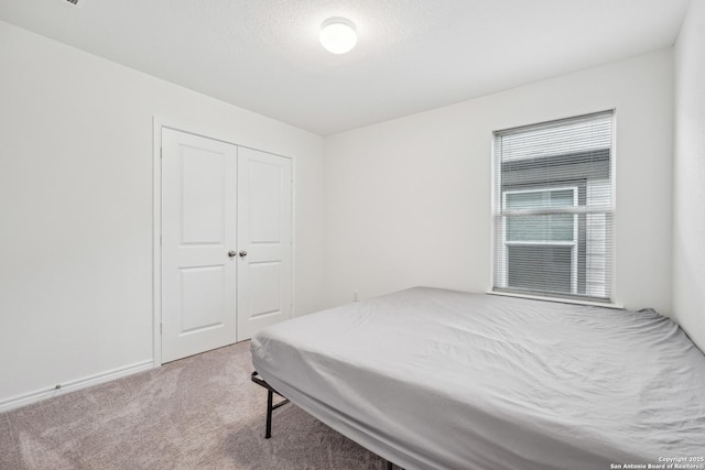 bedroom with carpet floors and a closet