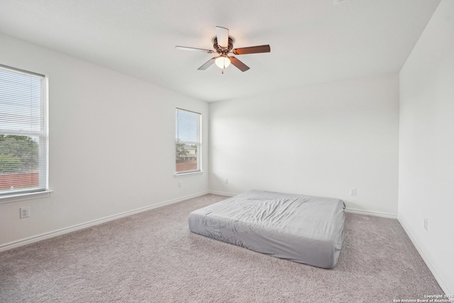 bedroom featuring baseboards, ceiling fan, and carpet flooring