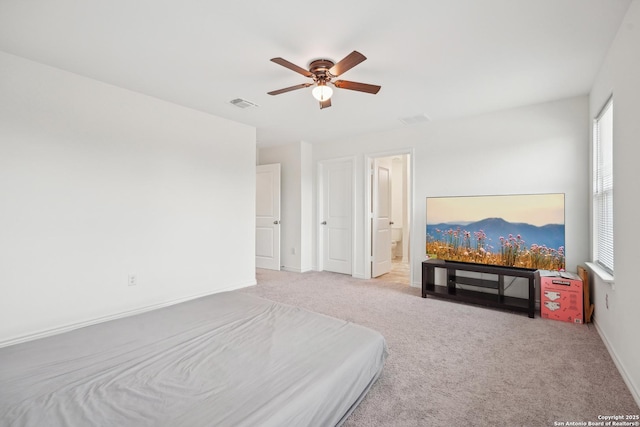 bedroom with multiple windows, light carpet, and visible vents