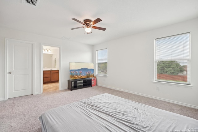 bedroom with baseboards, light carpet, and visible vents