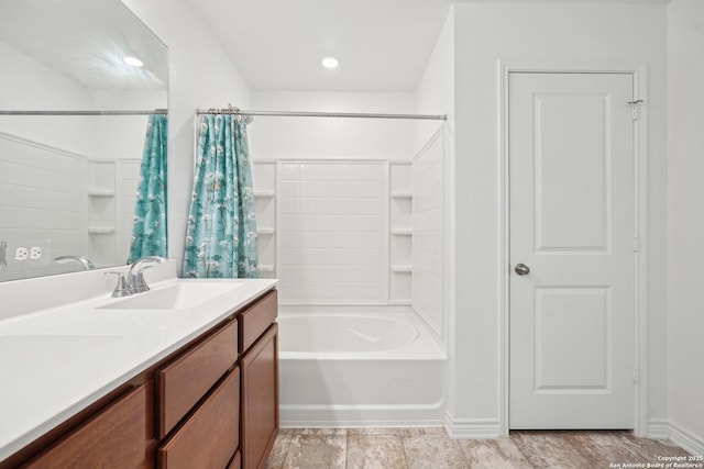 bathroom with double vanity, a sink, and shower / tub combo