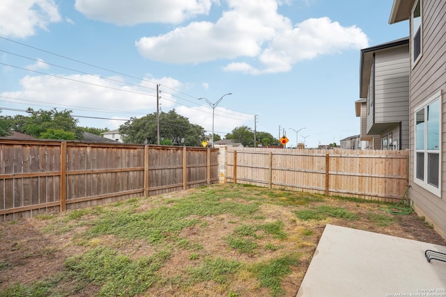 view of yard featuring a patio and a fenced backyard