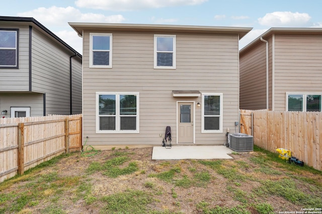 back of house featuring a patio, a fenced backyard, and central air condition unit