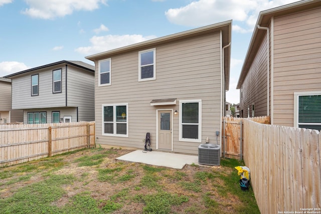 back of house with a fenced backyard, a patio area, and central AC
