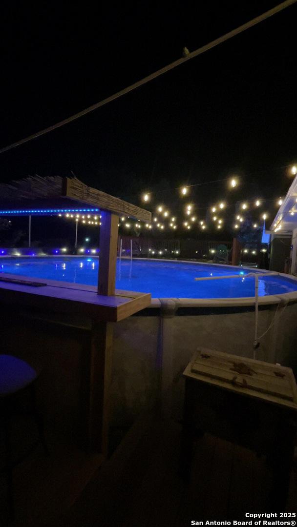 pool at twilight featuring a community pool