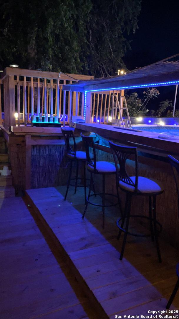 deck at twilight with a jacuzzi