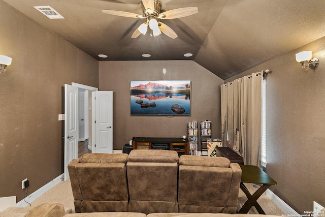 home theater featuring baseboards, visible vents, ceiling fan, and lofted ceiling